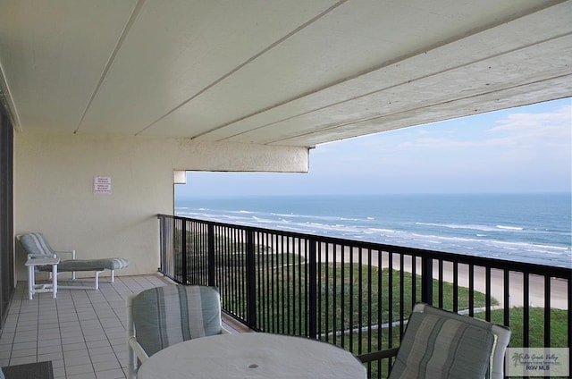 balcony featuring a water view and a view of the beach