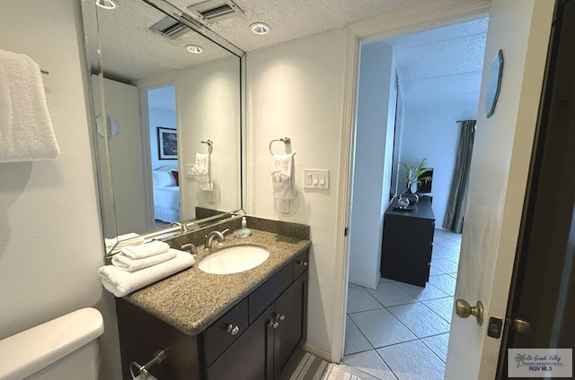 bathroom with tile patterned floors, vanity, and toilet