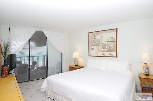 bedroom with light tile patterned floors and access to outside