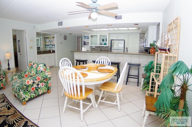 dining area featuring ceiling fan and light tile patterned flooring