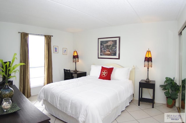 tiled bedroom with multiple windows