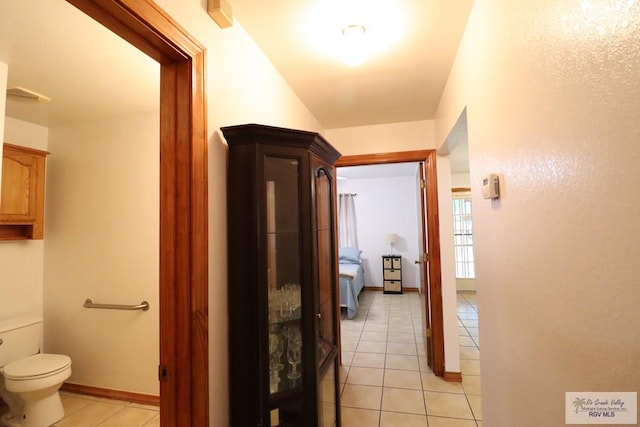 hall with light tile patterned floors