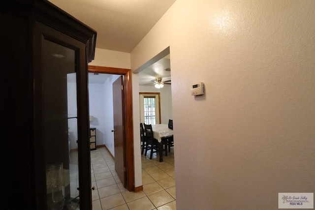 hall with light tile patterned floors