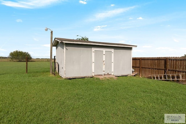 view of outdoor structure featuring a lawn