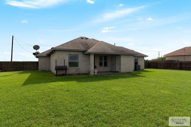 back of property with a patio area and a yard