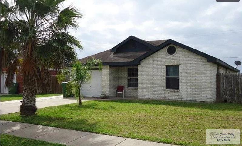 ranch-style home with a front lawn and a garage