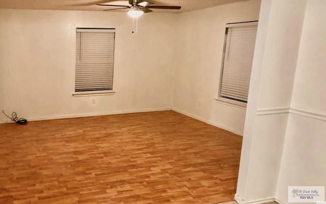 spare room with ceiling fan and light wood-type flooring