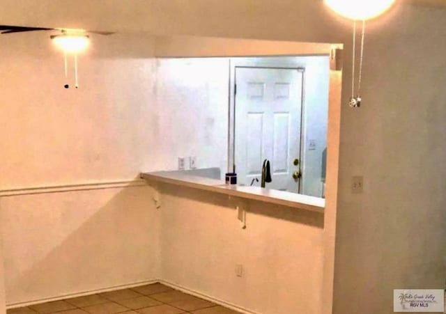 interior space featuring tile patterned flooring and sink