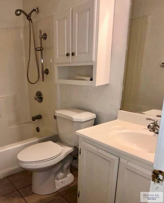 full bathroom with tile patterned floors, vanity, tiled shower / bath combo, and toilet