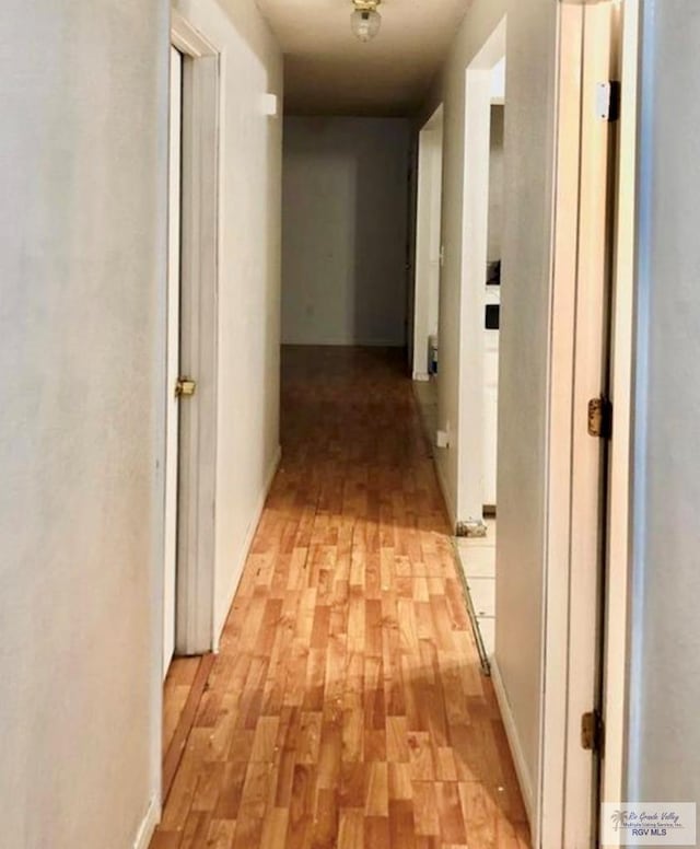 corridor with light wood-type flooring