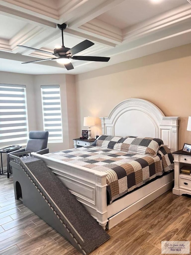 bedroom with a ceiling fan, beam ceiling, coffered ceiling, and wood finished floors