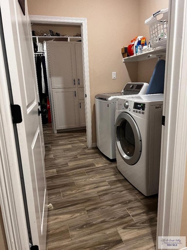 laundry area featuring laundry area, washer and clothes dryer, and dark wood-type flooring