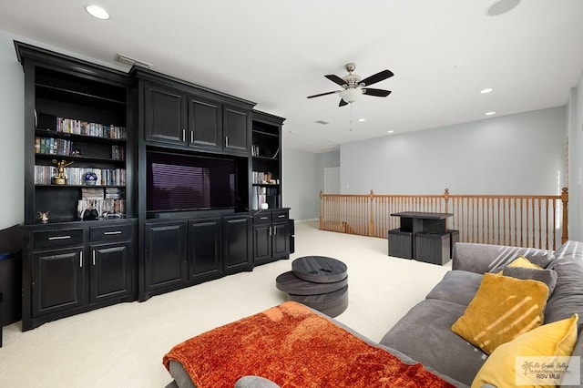 living room featuring ceiling fan and light colored carpet