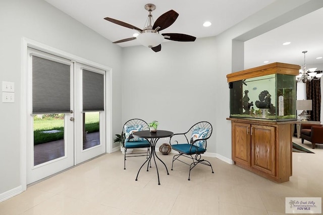 dining area with ceiling fan with notable chandelier