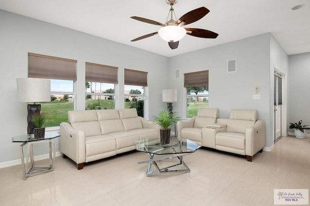 tiled living room featuring ceiling fan