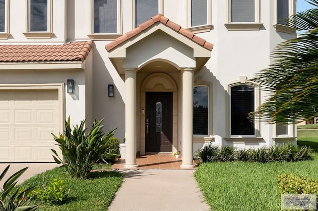 view of exterior entry with a garage