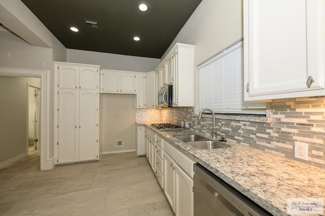 1101 Chico Cir, Harlingen, TX 78552 - kitchen featuring a sink, white cabinets, visible vents, and appliances with stainless steel finishes