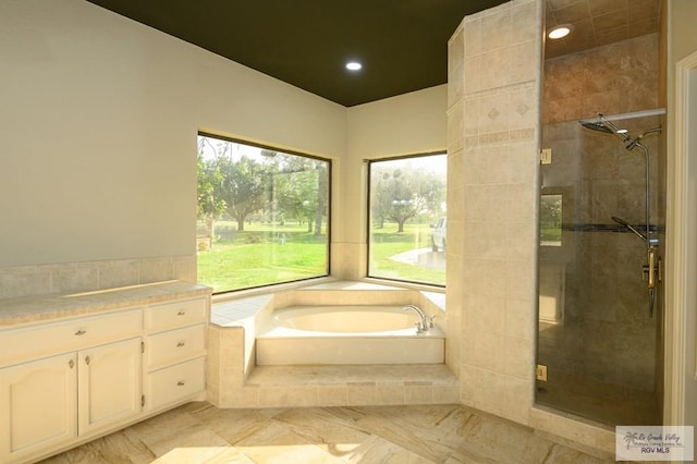 1101 Chico Cir, Harlingen, TX 78552 - bathroom with a bath, a wealth of natural light, a stall shower, and recessed lighting