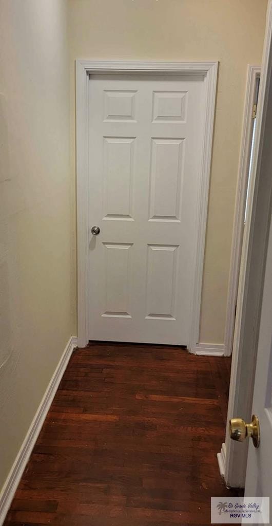 hallway with dark hardwood / wood-style floors