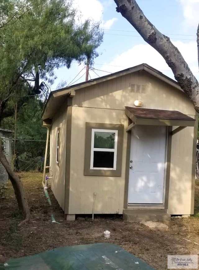 view of property exterior with an outbuilding