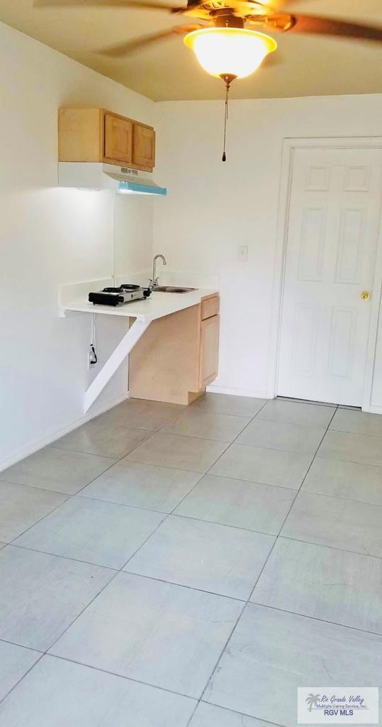 kitchen featuring sink and light tile patterned floors