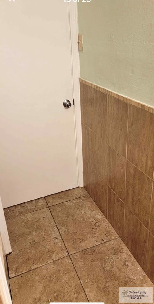 bathroom with tile walls