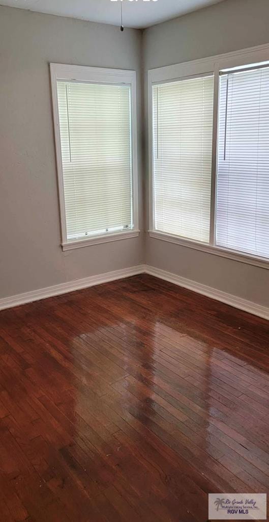 spare room featuring dark hardwood / wood-style flooring