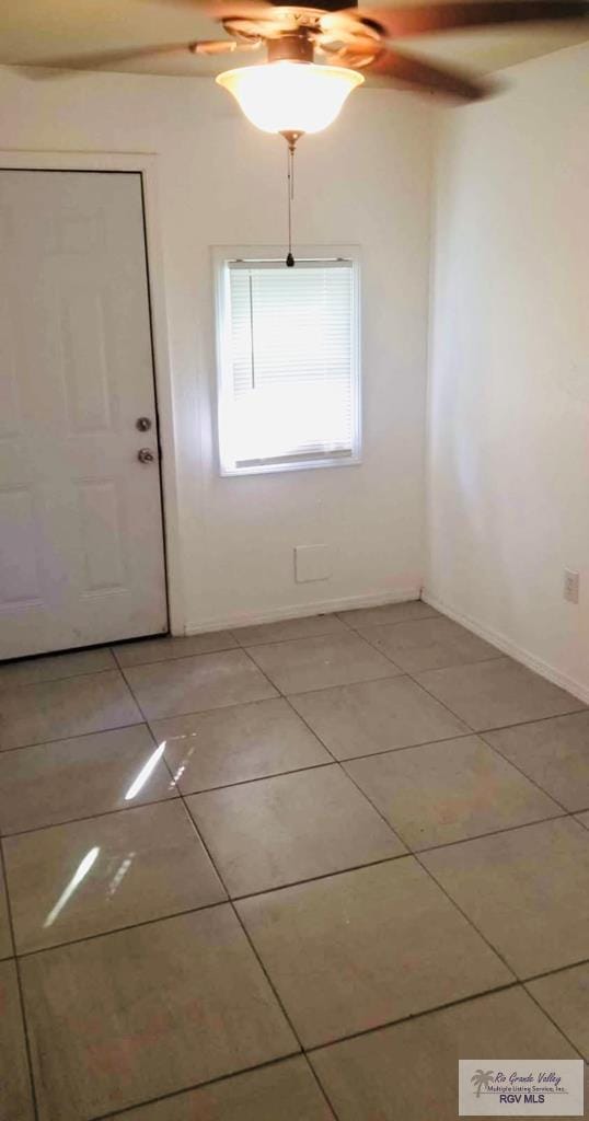 unfurnished room featuring ceiling fan and light tile patterned floors