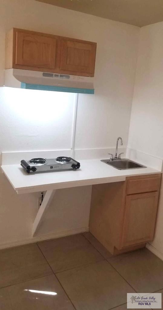 kitchen with sink and light tile patterned floors