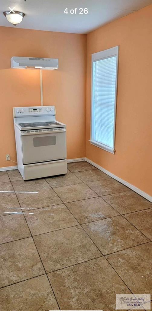 kitchen featuring tile patterned flooring and white range with electric stovetop