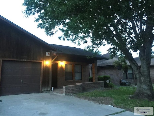 6212 NW King Arthur Ct, Harlingen, TX 78550 - view of front of property featuring a garage, driveway, and brick siding