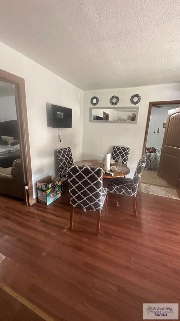 interior space featuring a textured ceiling and wood finished floors