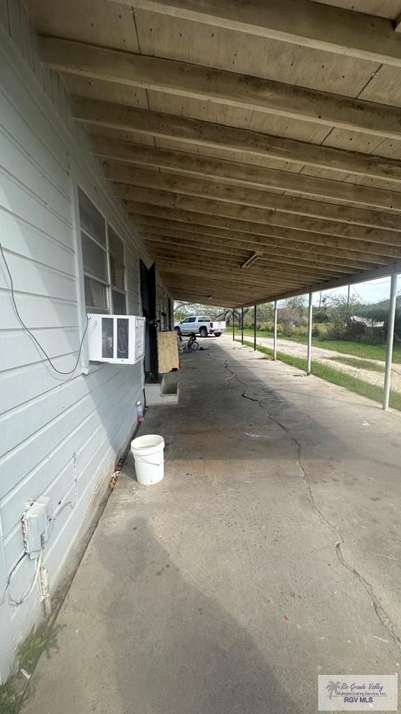 view of patio / terrace with cooling unit and an attached carport