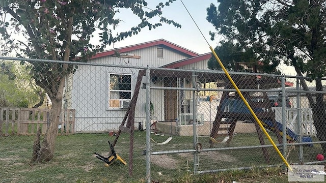 view of front of house with an outbuilding and fence