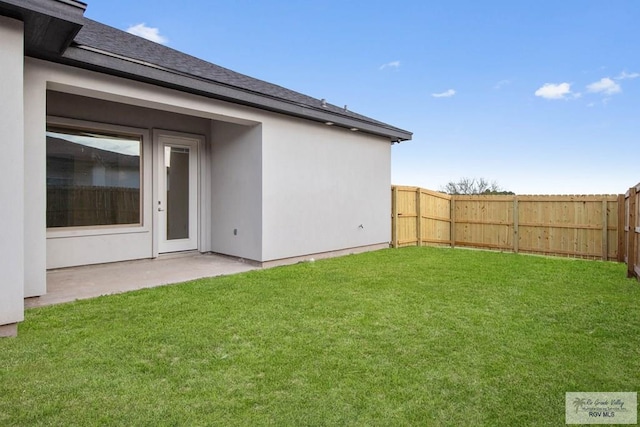 view of yard featuring a patio area and a fenced backyard