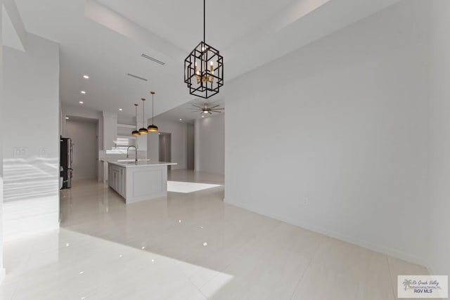 interior space with ceiling fan, a sink, and recessed lighting