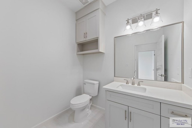 half bathroom with baseboards, visible vents, toilet, tile patterned floors, and vanity