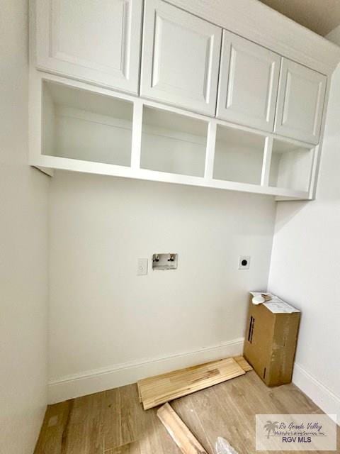 washroom featuring cabinets, washer hookup, light hardwood / wood-style flooring, and electric dryer hookup