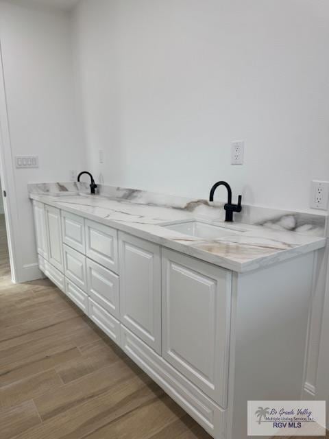 bathroom featuring vanity and wood-type flooring