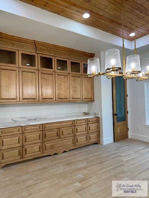 kitchen with hanging light fixtures, light hardwood / wood-style flooring, and wooden ceiling