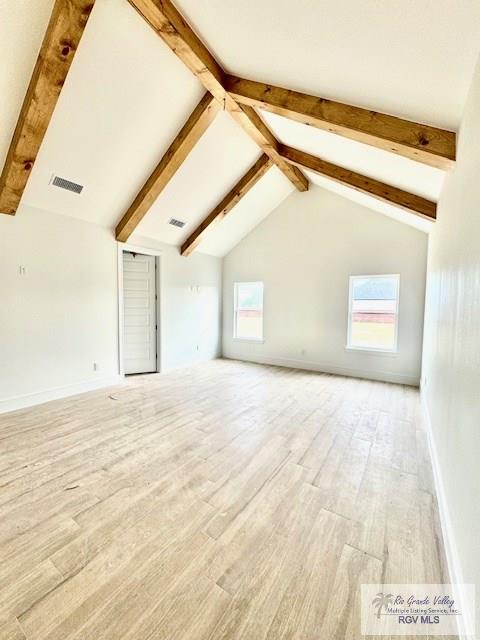 unfurnished living room featuring high vaulted ceiling, beam ceiling, and light hardwood / wood-style floors