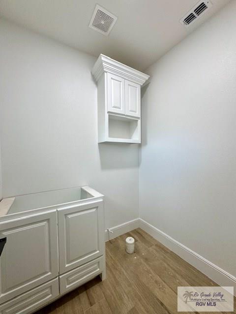 laundry area featuring dark hardwood / wood-style flooring