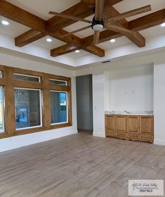 spare room with coffered ceiling, light hardwood / wood-style flooring, and ceiling fan