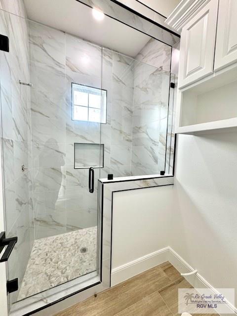 bathroom with a shower with door