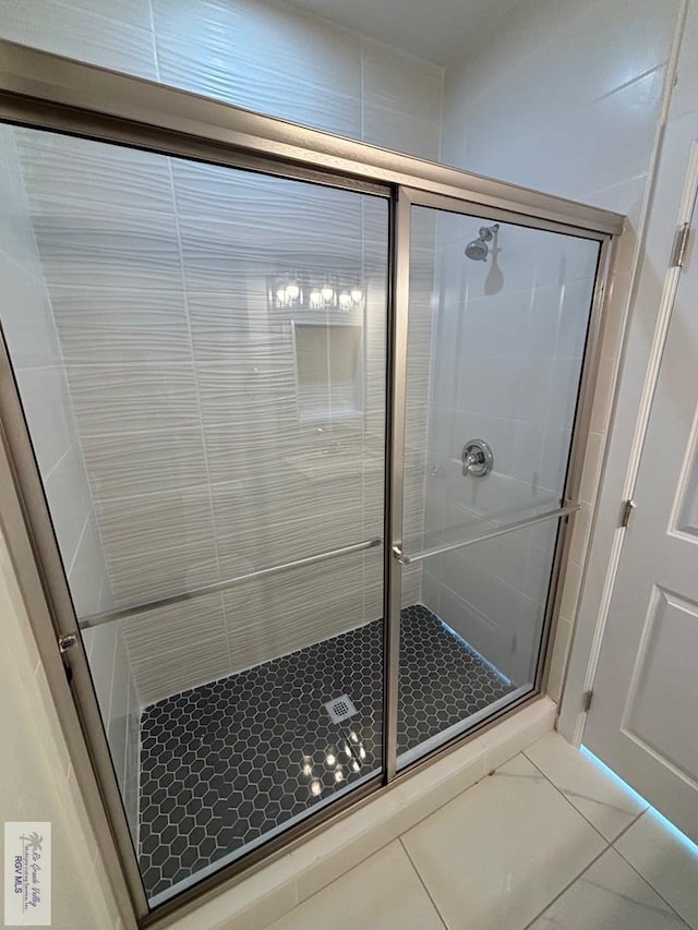 bathroom featuring tile patterned flooring and an enclosed shower