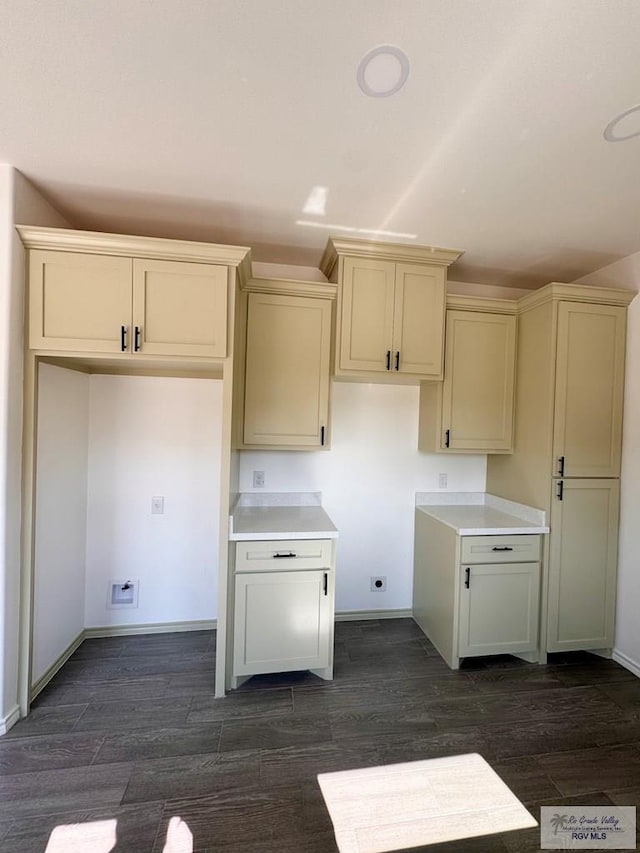 kitchen with cream cabinets and dark hardwood / wood-style flooring