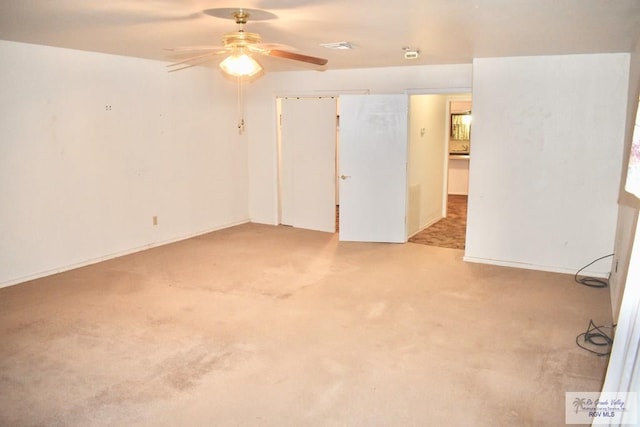 unfurnished room with ceiling fan and carpet floors