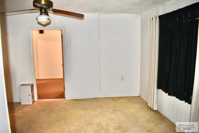 unfurnished room with light colored carpet and ceiling fan