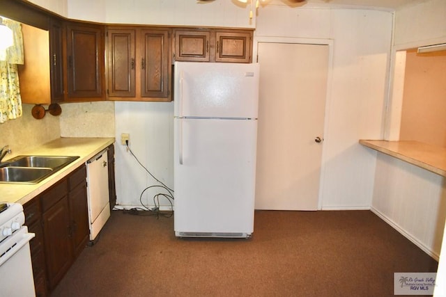 kitchen featuring decorative backsplash, sink, white appliances, and dark colored carpet