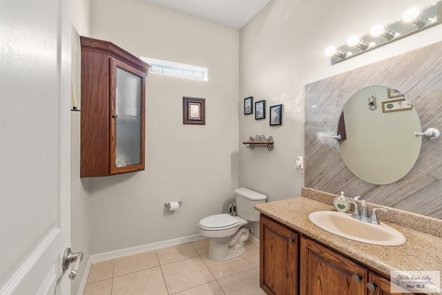 bathroom featuring tile patterned floors, toilet, and vanity